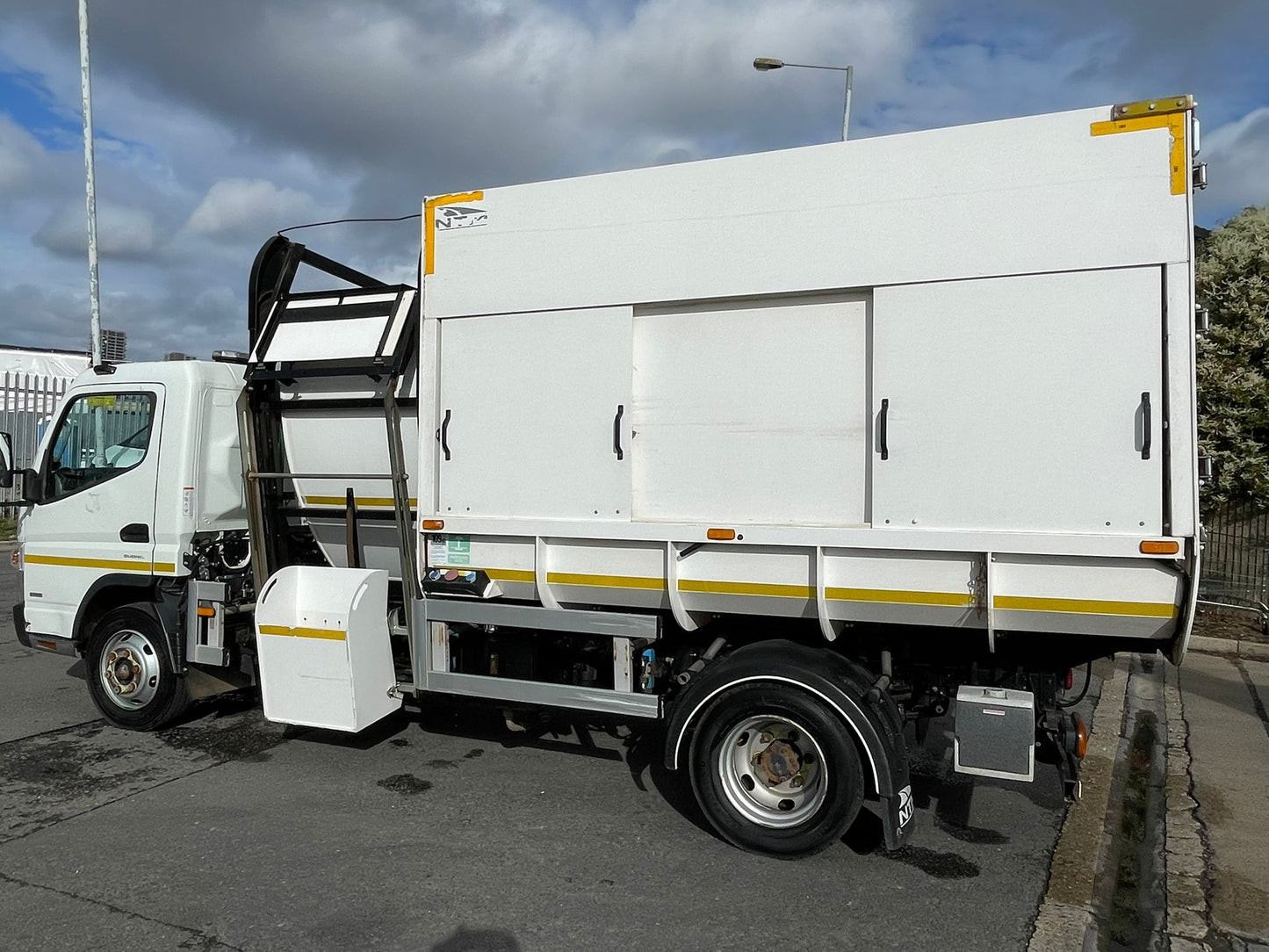White utility truck with a cargo area on a street